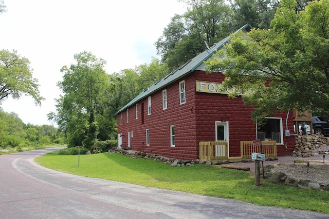 view of property exterior with a lawn