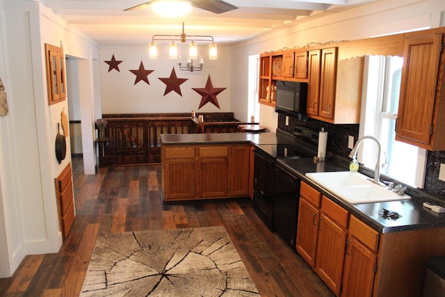 kitchen with beamed ceiling, hanging light fixtures, sink, black appliances, and dark hardwood / wood-style flooring