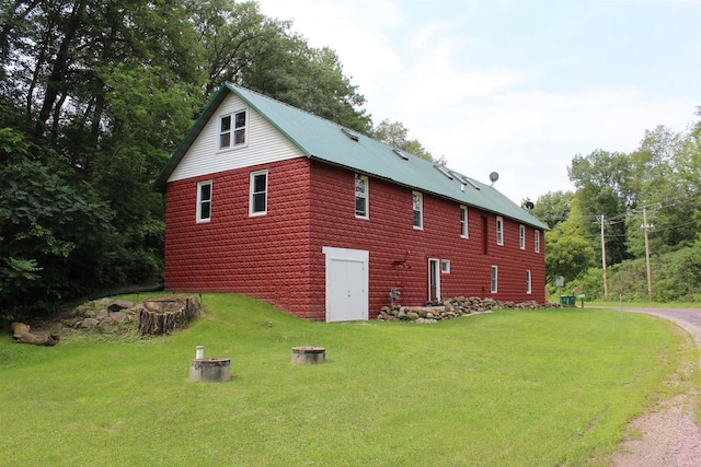 view of side of home with a yard