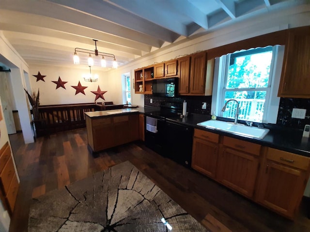 kitchen featuring black appliances, sink, dark hardwood / wood-style flooring, hanging light fixtures, and backsplash