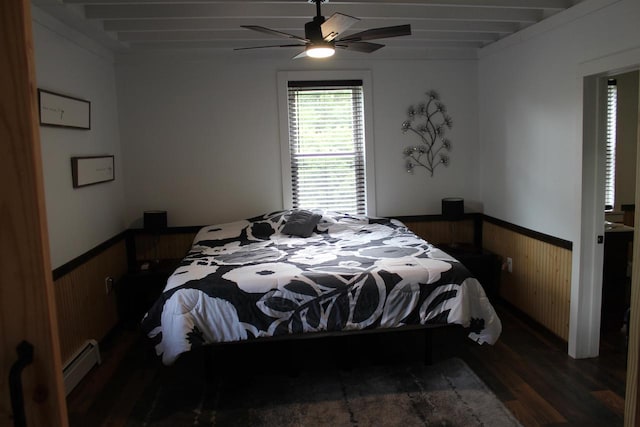 bedroom with beam ceiling, wooden walls, ceiling fan, and dark hardwood / wood-style flooring