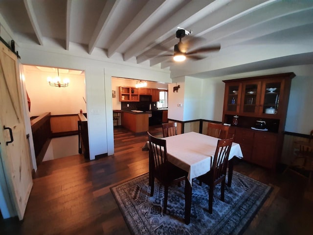 dining space with ceiling fan with notable chandelier, beamed ceiling, a barn door, and dark hardwood / wood-style flooring