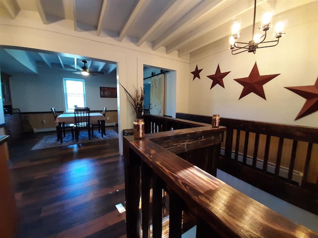 stairway with beamed ceiling, hardwood / wood-style flooring, and ceiling fan with notable chandelier