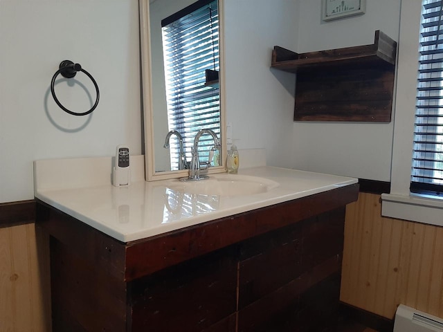 bathroom featuring a wealth of natural light, a baseboard radiator, and vanity