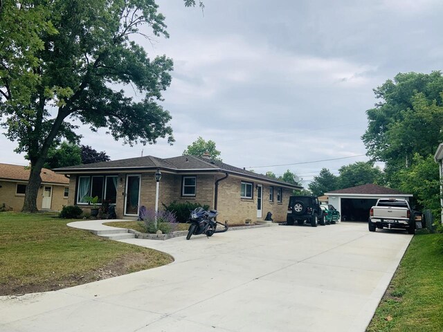 view of front of property featuring a garage and a front lawn