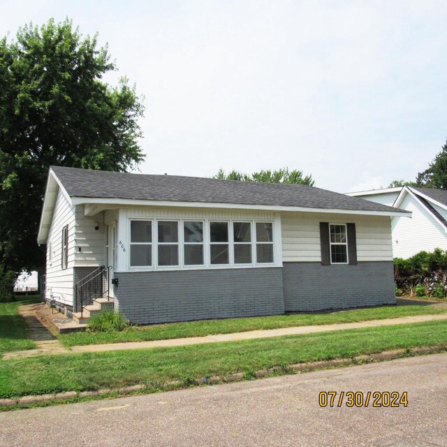 single story home featuring a front lawn