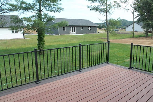 wooden terrace featuring a yard