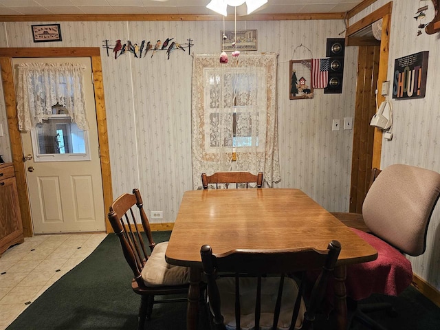 tiled dining room featuring wooden walls