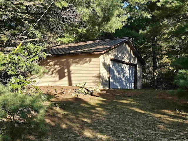 view of side of property featuring an outbuilding and a garage