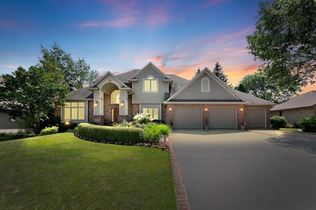 craftsman house with a garage and a yard