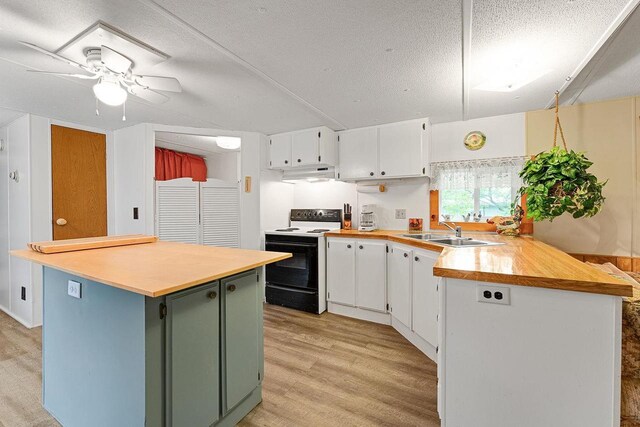 kitchen featuring sink, white cabinetry, electric range oven, kitchen peninsula, and light hardwood / wood-style floors