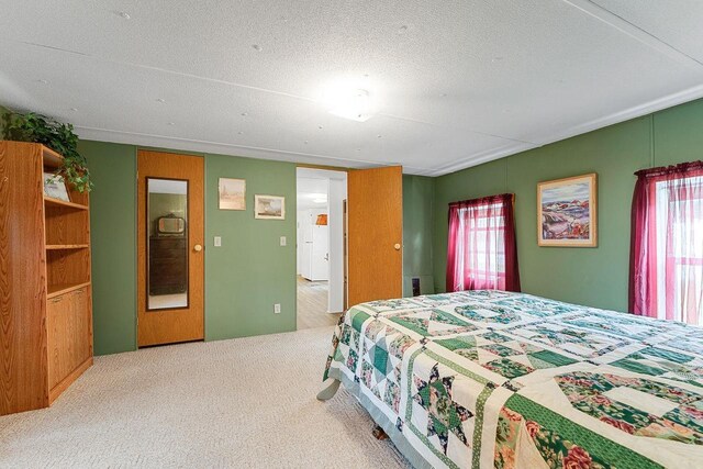 carpeted bedroom featuring a textured ceiling