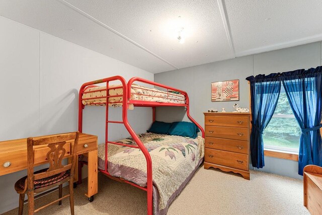 carpeted bedroom with a textured ceiling