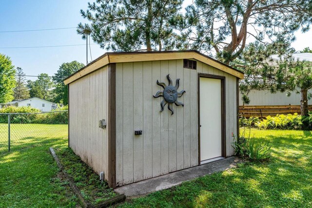 view of outdoor structure featuring a lawn