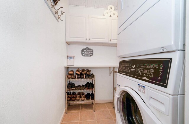 W12203 State Road 23, Ripon, WI 54971 - clothes washing area featuring stacked washer / drying machine, cabinets, and light tile patterned floors