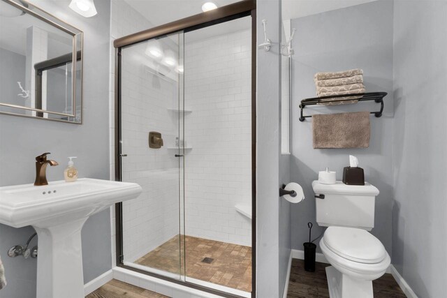 W12203 State Road 23, Ripon, WI 54971 - bathroom featuring hardwood / wood-style flooring, a shower with shower door, and toilet