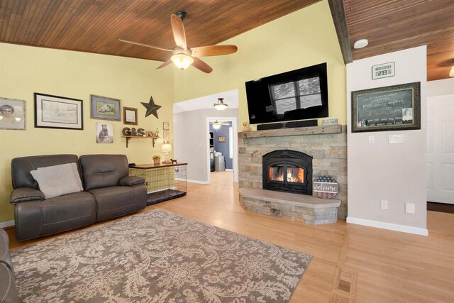 W12203 State Road 23, Ripon, WI 54971 - living room featuring a stone fireplace, light hardwood / wood-style flooring, ceiling fan, and wood ceiling