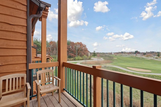 wooden terrace featuring a lawn