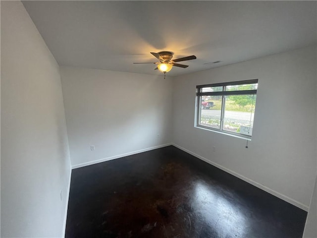 unfurnished room featuring concrete floors and ceiling fan