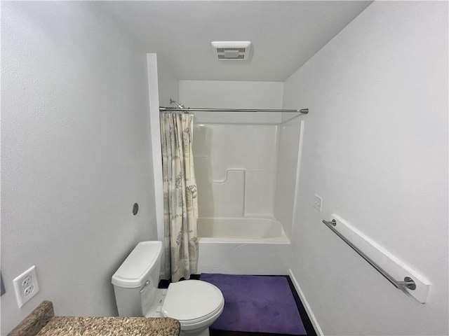 bathroom with toilet and shower / tub combo