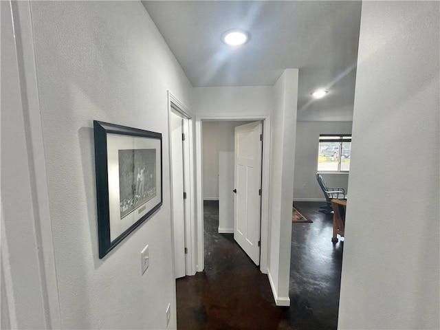 hallway with dark hardwood / wood-style flooring