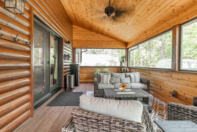 sunroom featuring ceiling fan, wood ceiling, vaulted ceiling, and a wealth of natural light