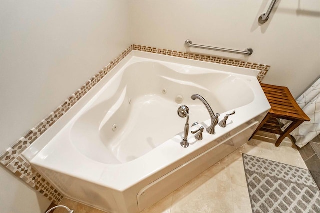 bathroom with a relaxing tiled tub and tile patterned floors