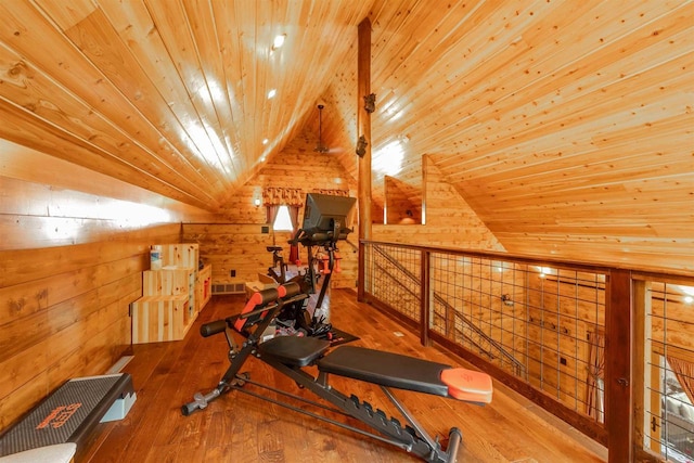 exercise area featuring wood ceiling, vaulted ceiling, hardwood / wood-style flooring, and wood walls