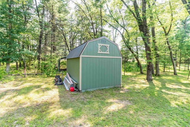 view of outbuilding with a yard