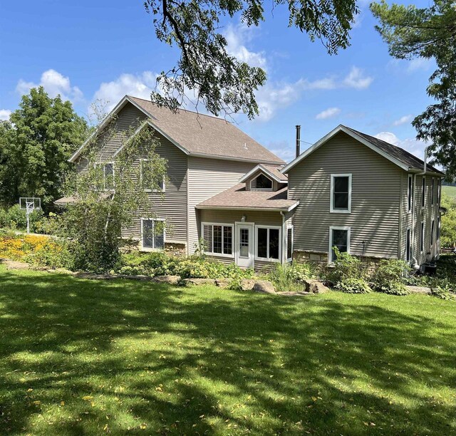 back of house with a lawn