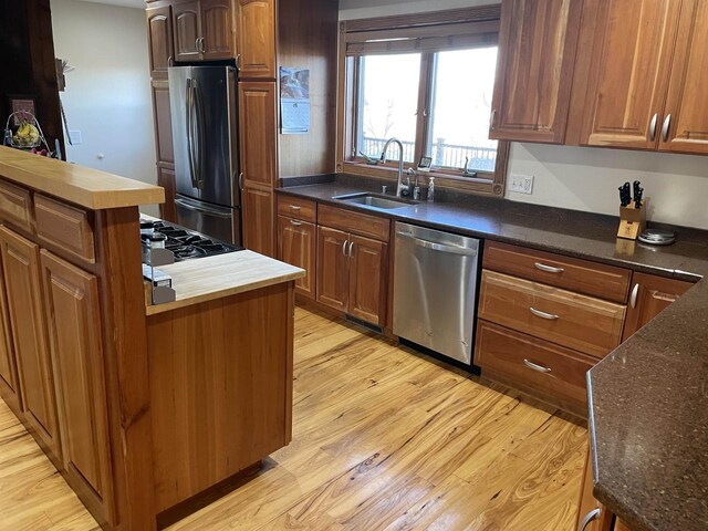 kitchen featuring sink, light hardwood / wood-style floors, and stainless steel appliances