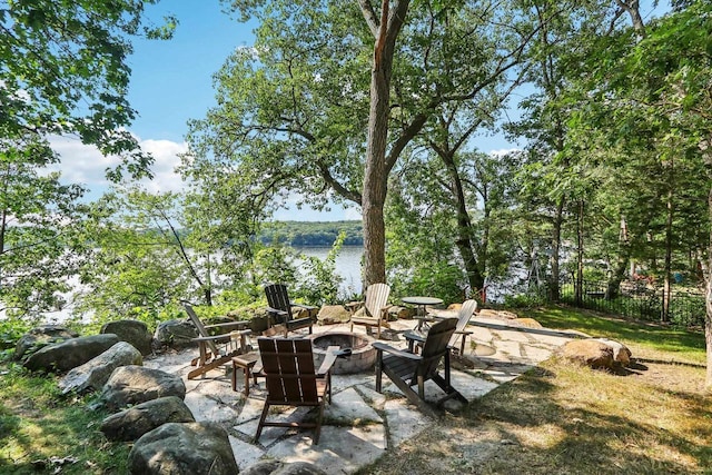 view of patio / terrace featuring fence and a fire pit