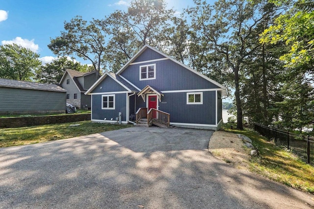 view of front of home featuring fence