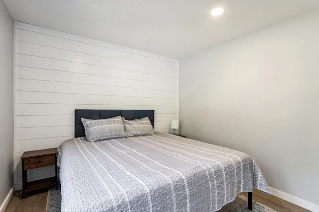 bedroom featuring wood finished floors, baseboards, and recessed lighting