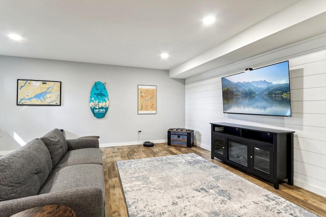 living room with wood finished floors, baseboards, and recessed lighting