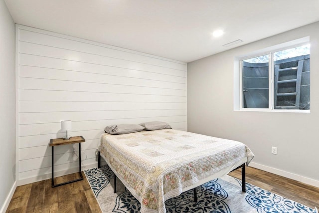 bedroom featuring baseboards and wood finished floors