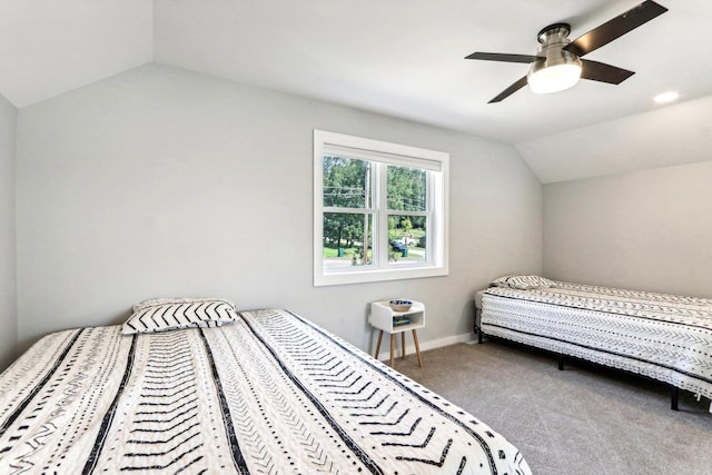 carpeted bedroom featuring baseboards, a ceiling fan, and lofted ceiling
