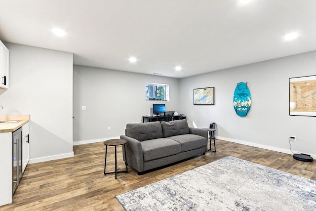 living room with baseboards, recessed lighting, and wood finished floors