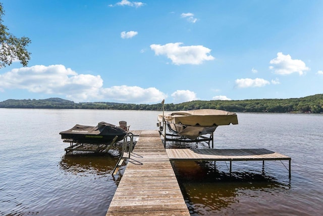 view of dock featuring a water view and boat lift