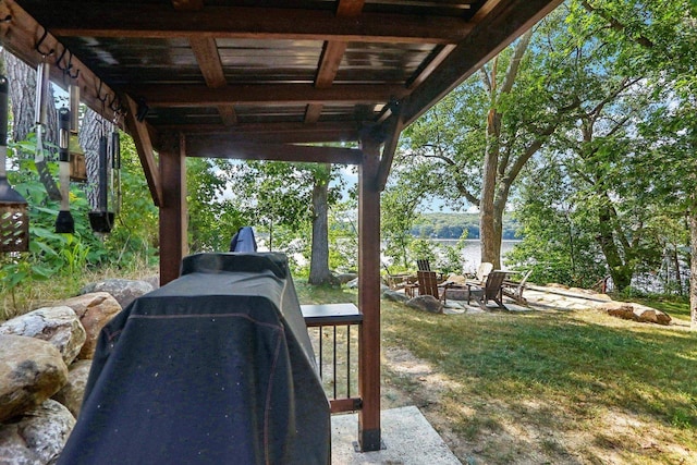 view of yard featuring a water view and a fire pit