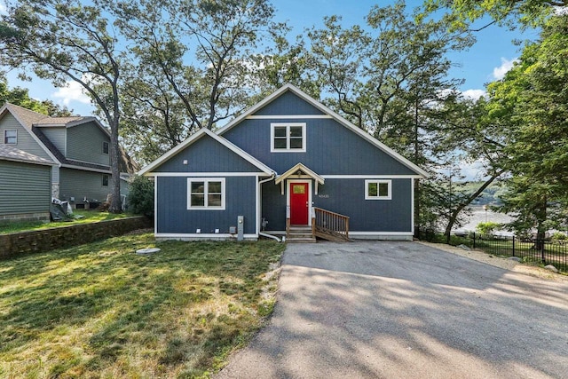 view of front of property with fence and a front lawn
