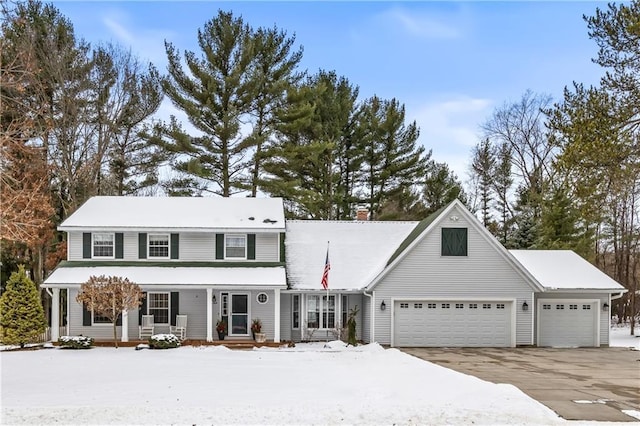 view of front of property featuring a front lawn, a garage, and a porch