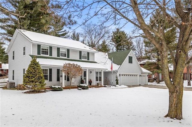 view of front of home with a front lawn, cooling unit, covered porch, and a garage