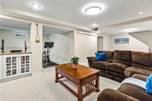 living room with light carpet and a wall mounted AC