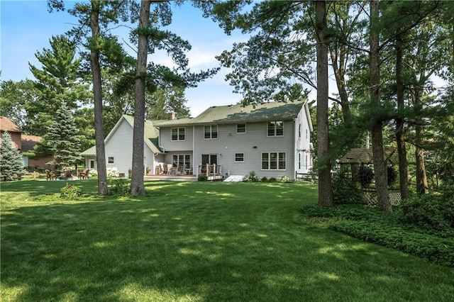 rear view of property with a yard