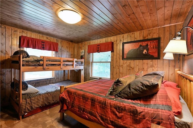 bedroom with carpet floors, wooden ceiling, and wooden walls