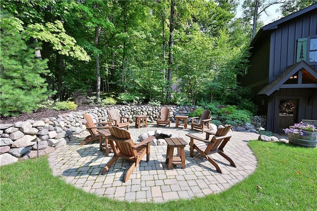 view of patio / terrace featuring exterior fireplace and an outdoor fire pit