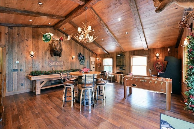 recreation room with wooden walls, dark hardwood / wood-style floors, vaulted ceiling with beams, and wood ceiling