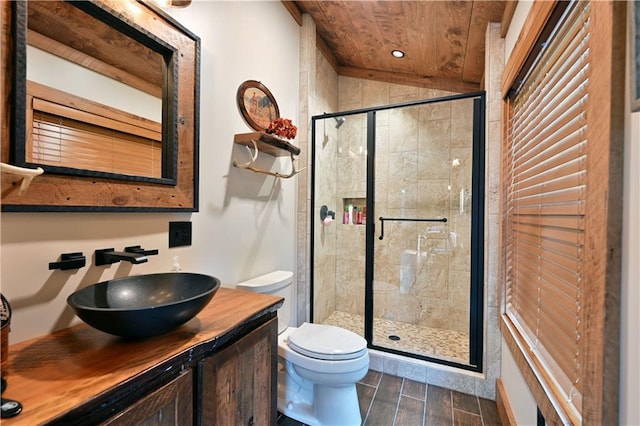 bathroom featuring lofted ceiling, wood ceiling, vanity, a shower with shower door, and toilet