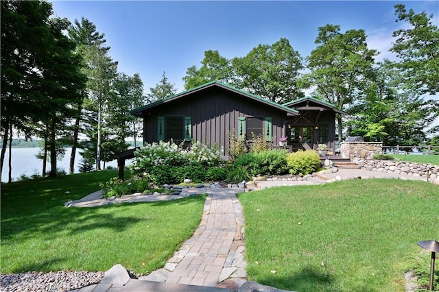 view of front of property with a water view and a front yard